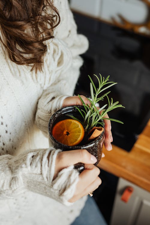 Free Woman in White Sweater Holding Green Plant Stock Photo