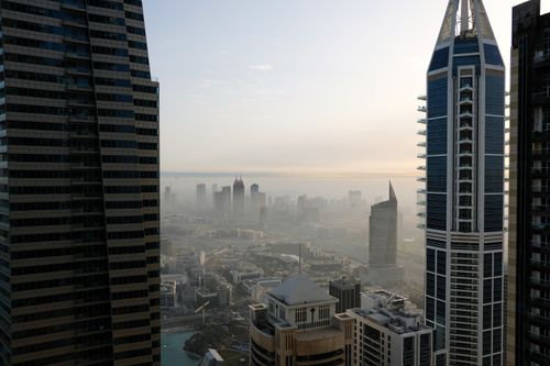 Free Aerial view of a cityscape with modern skyscrapers and urban skyline at dawn. Stock Photo