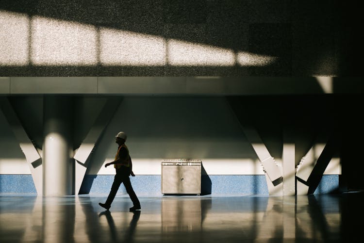 Man In Reflective Vest And Hard Hat Walking 