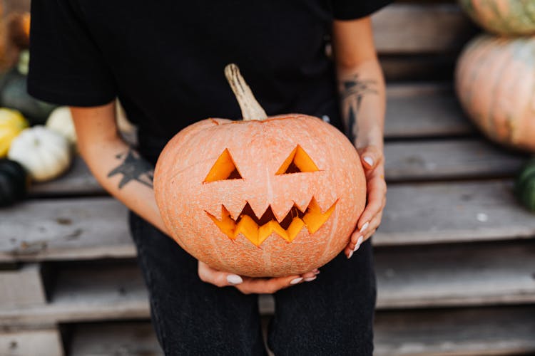 Man Holding A Carved Pumpkin 