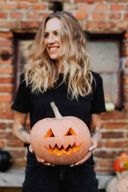 Woman Holding Carved Pumpkin