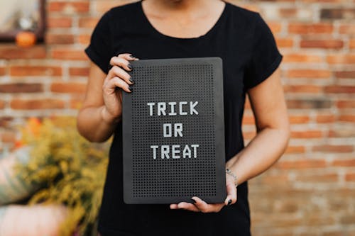Free Person Holding a Trick or Treat Sign Stock Photo
