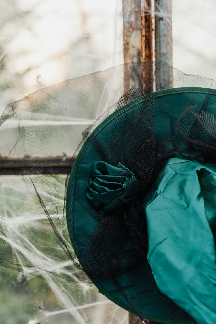 Close Up Of Spider Web Covered Window And Hat