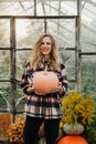 Woman in Black White and Red Plaid Dress Shirt Holding Brown Pumpkin