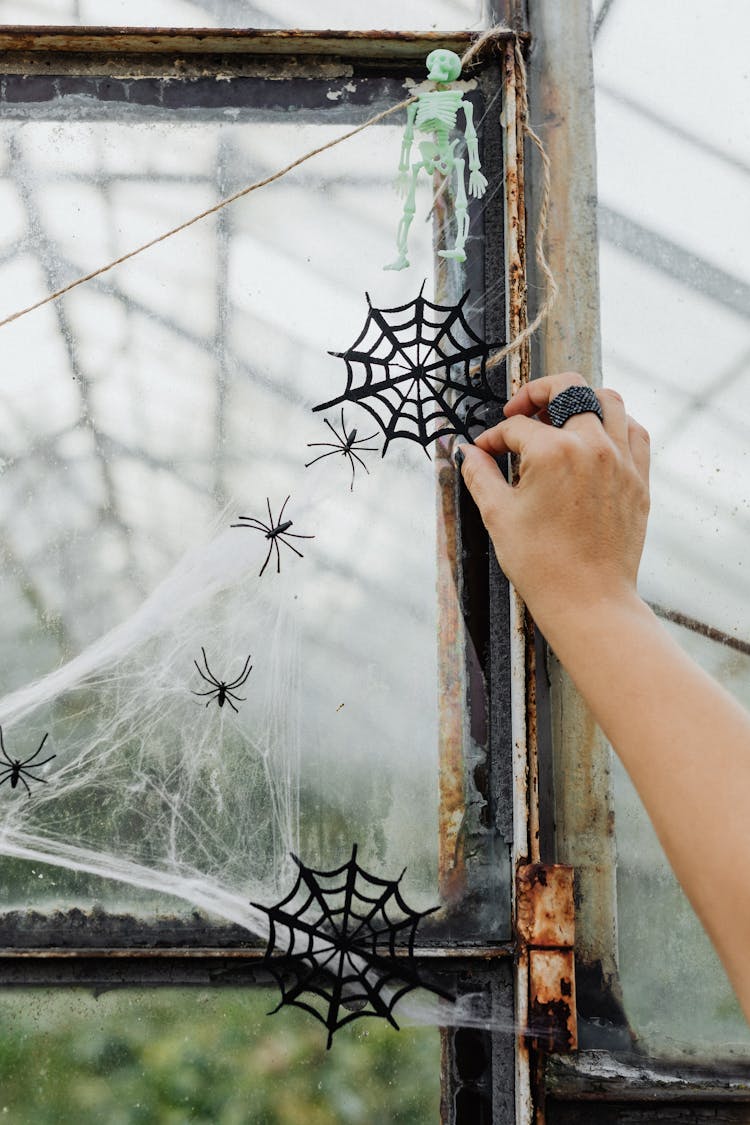 Hand Putting Halloween Decorations