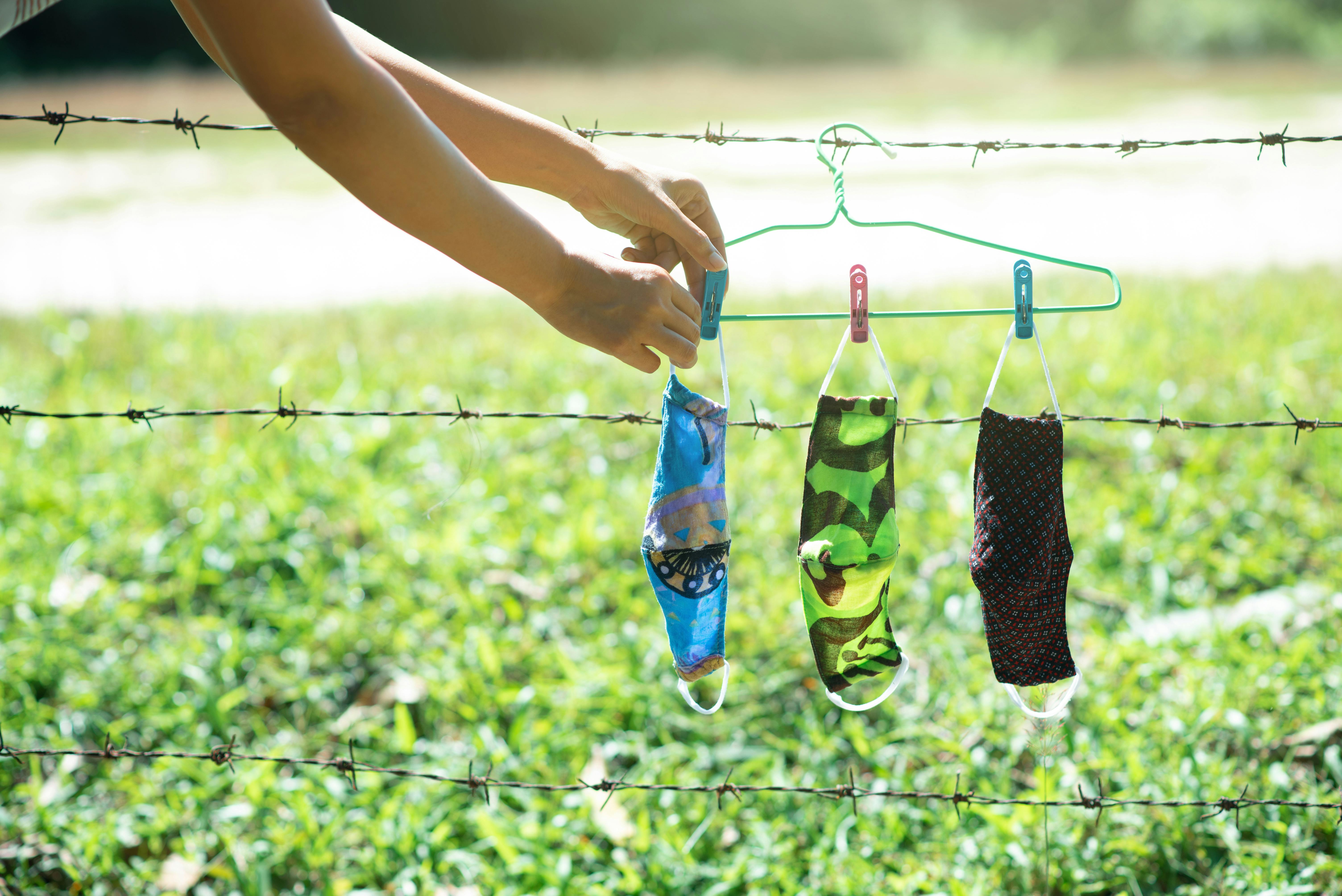 a person hanging face masks