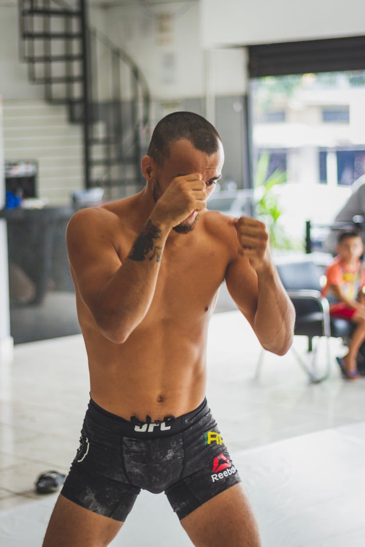 A Fighter In MMA Shorts Doing A Fighting Stance