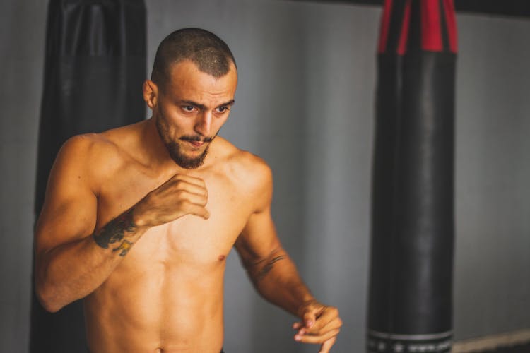 A Shirtless Man Doing Shadow Boxing 