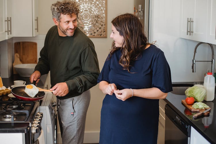 Positive Couple Cooking Breakfast Together