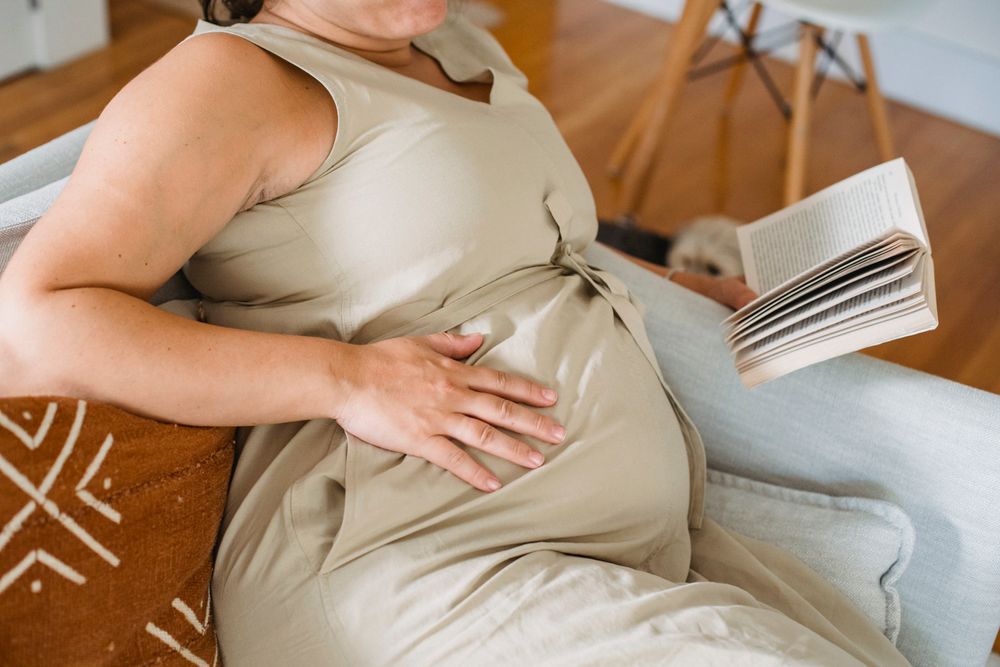 Expectant mother reading to prepare for birth