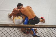 Fighters Grappling in a Ring