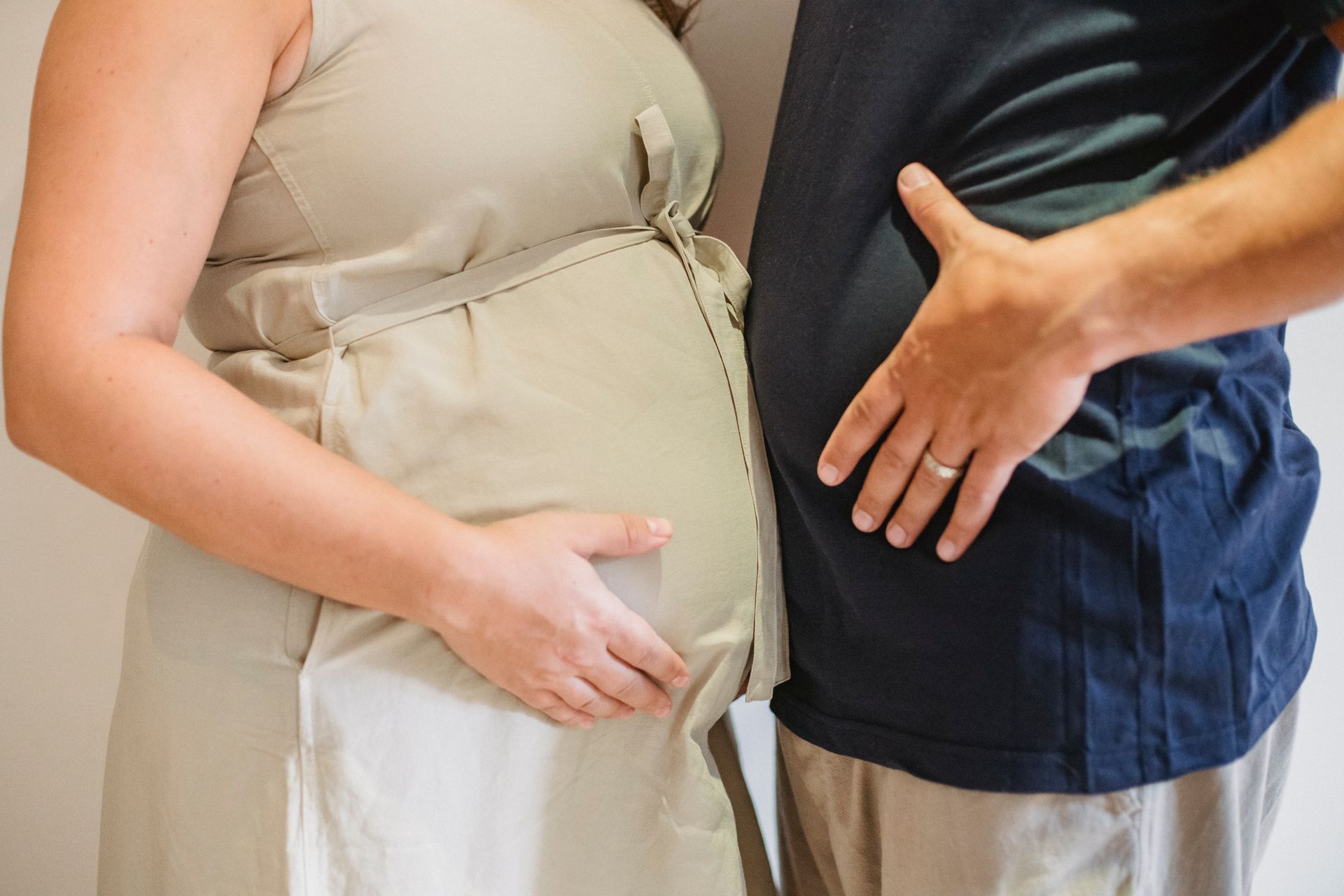 Faceless couple showing each other belly