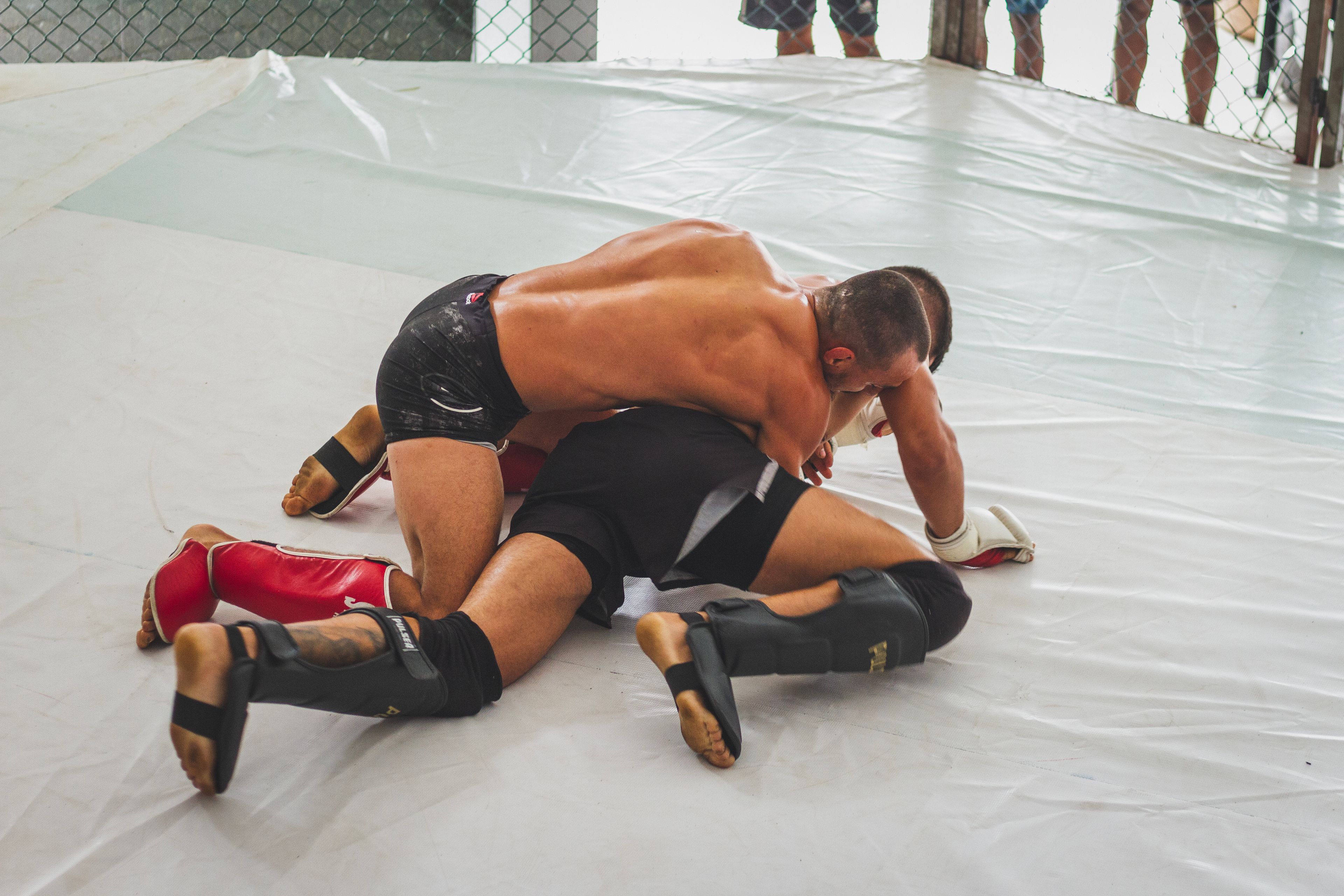 Two wrestlers in an intense grappling match on the mat