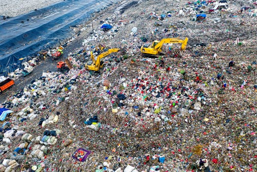 Aerial shot of a landfill in West Java with excavators and piles of trash, highlighting environmental issues.