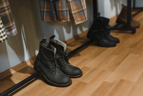 Free Black Leather Boots on Wooden Floor Stock Photo