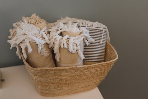 Brown ang White Textile on Brown Woven Basket