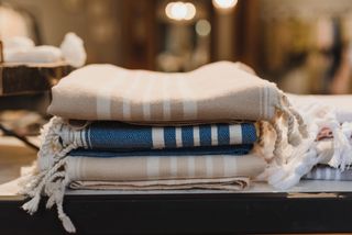 Stack of folded striped cotton throws — photo by Arina Krasnikova on Pexels