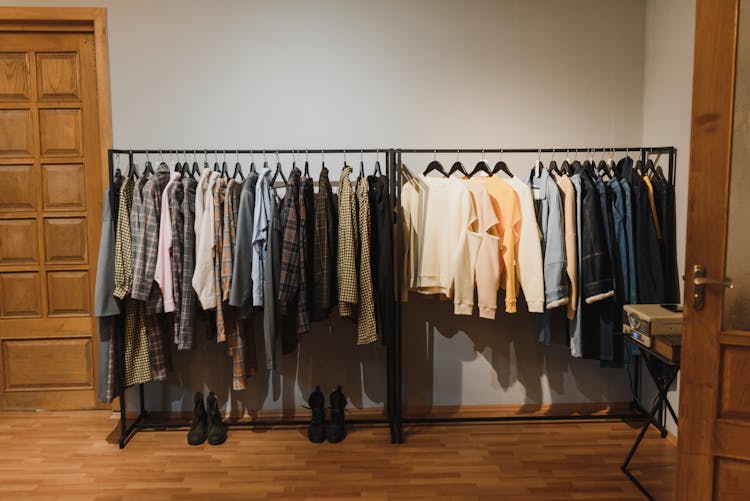 White And Black Clothes Hanging On Black Steel Rack