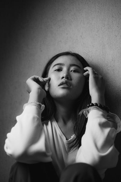 Woman in a White Long Sleeve Shirt Posing