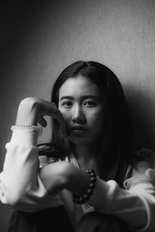 Free Artistic black-and-white portrait of a young woman conveying deep emotion. Stock Photo