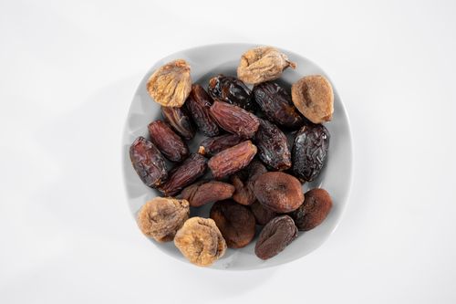 Assorted dried fruits on a white plate — photo by Engin Akyurt on Pexels