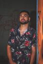 Man in Black and Red Floral Button Up Shirt