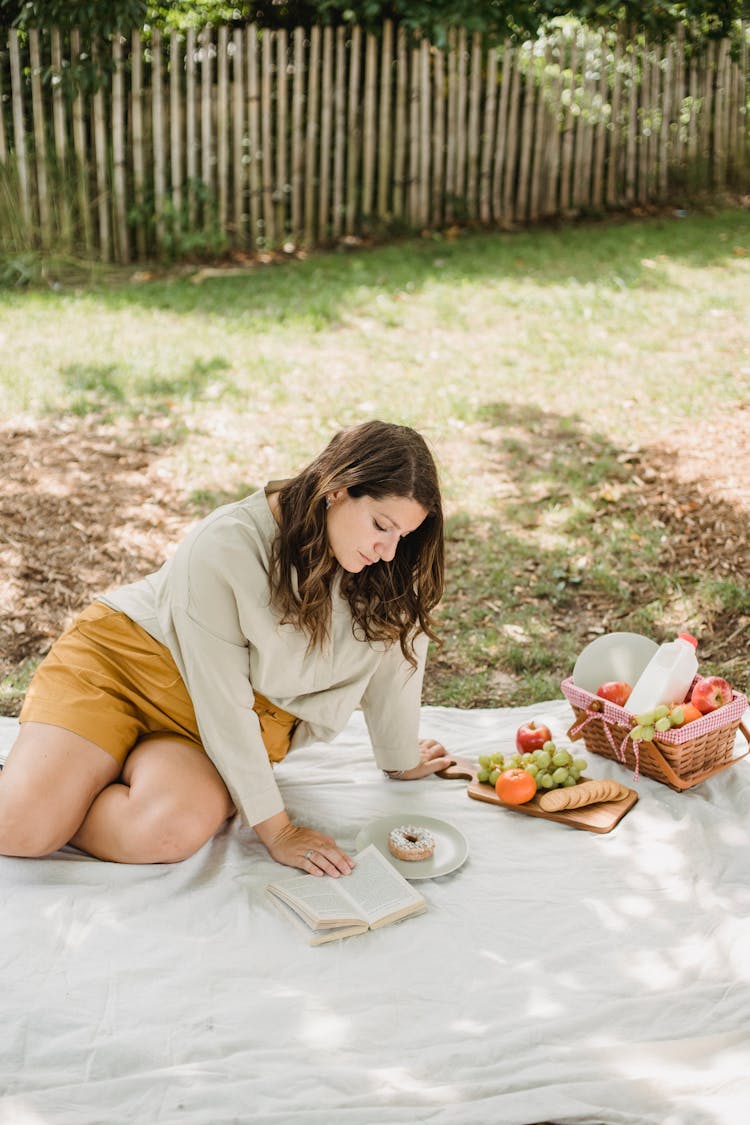 Pregnant Woman Having Picnic In Yard