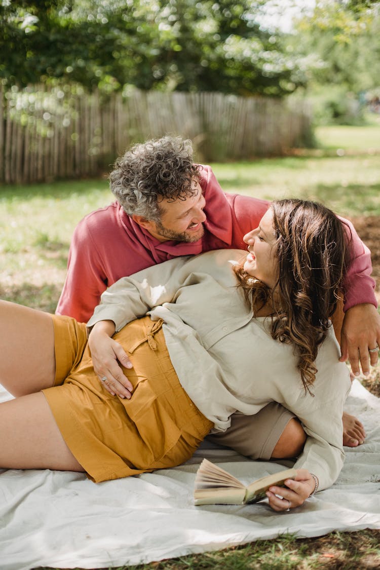 Couple Having Picnic Together In Yard