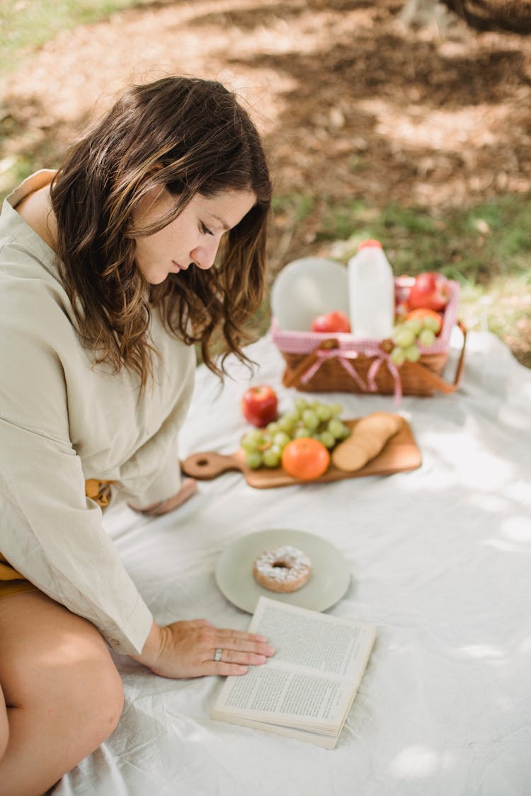 Peaceful Woman Reading Book In Nature