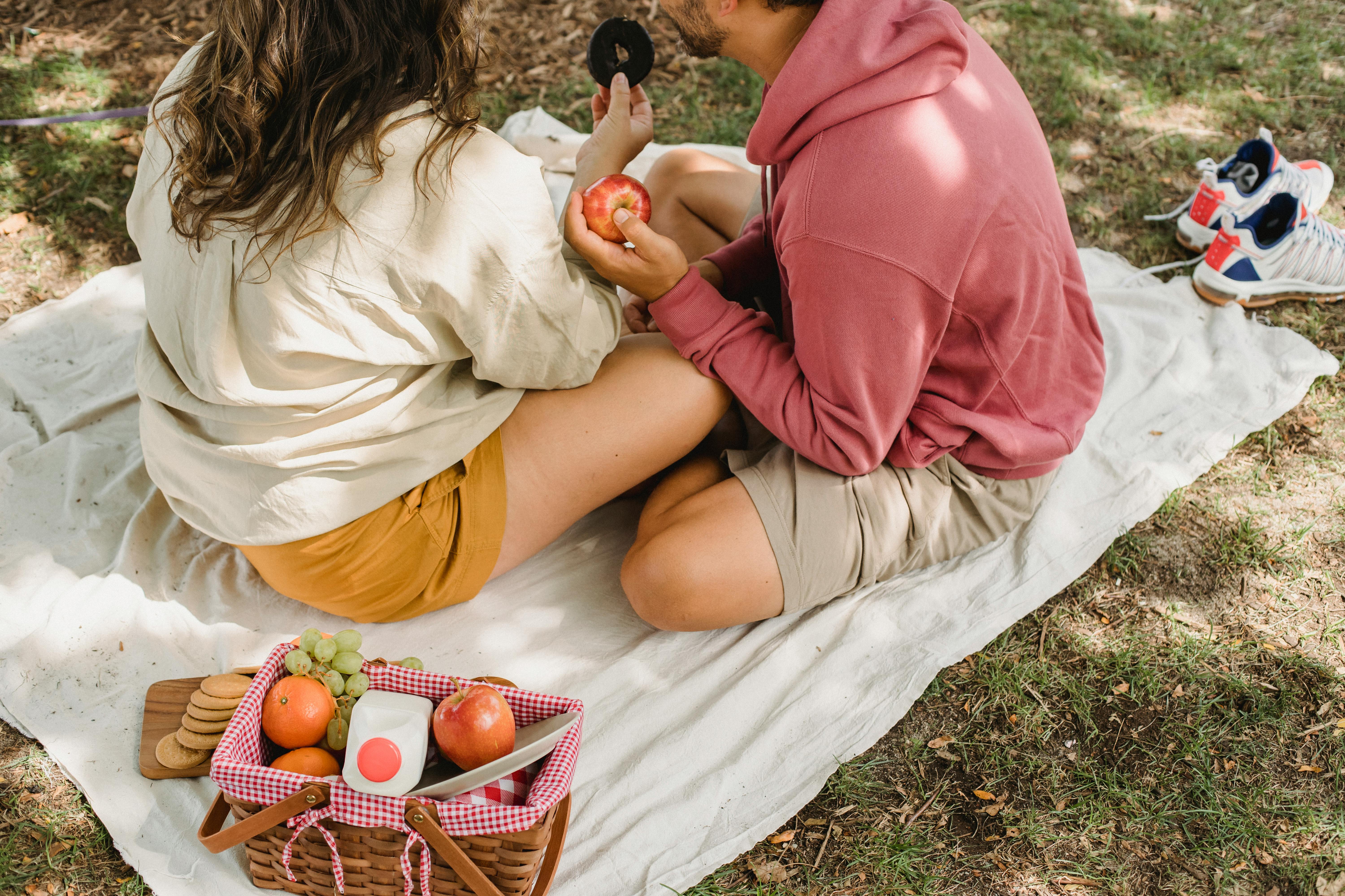 crop couple having picnic in nature