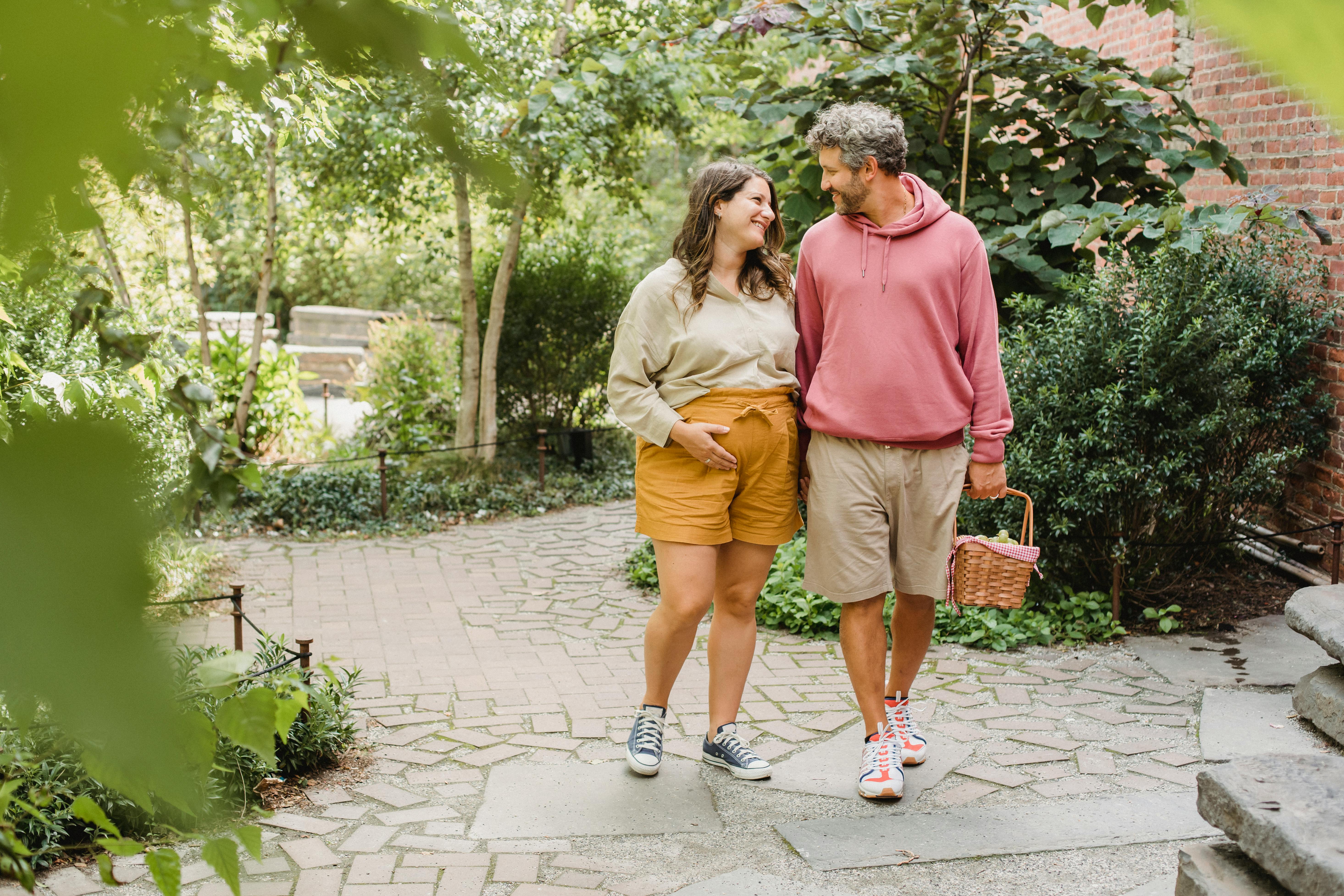 happy couple walking with basket for picnic