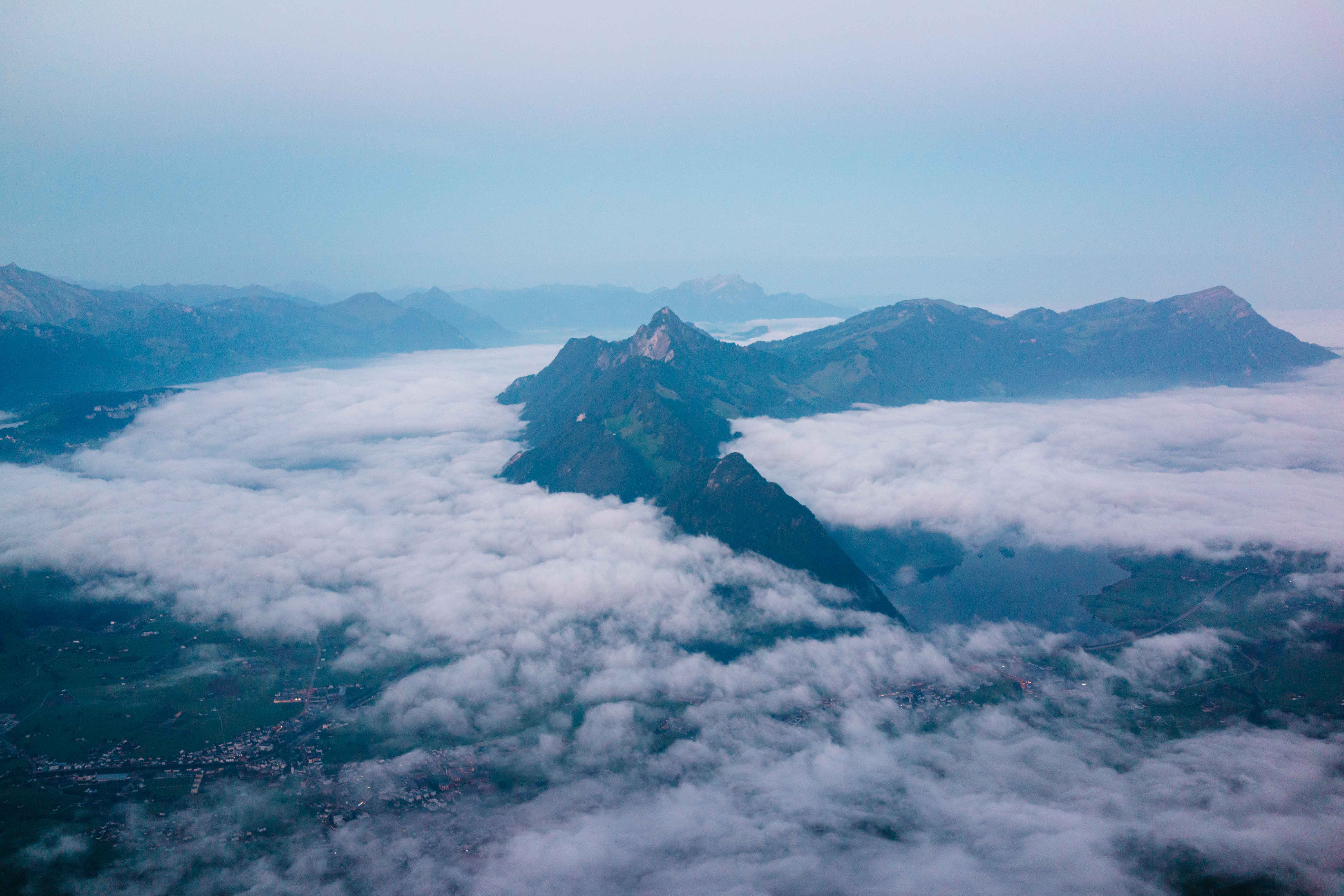 Ultimate Matterhorn Helicopter Tour - Longest Scenic Flight from Bern Over the Swiss Alps Review Review 2026 - A mesmerizing aerial view of the Swiss Alps with clouds and mountains near Schwyz, Switzerland.