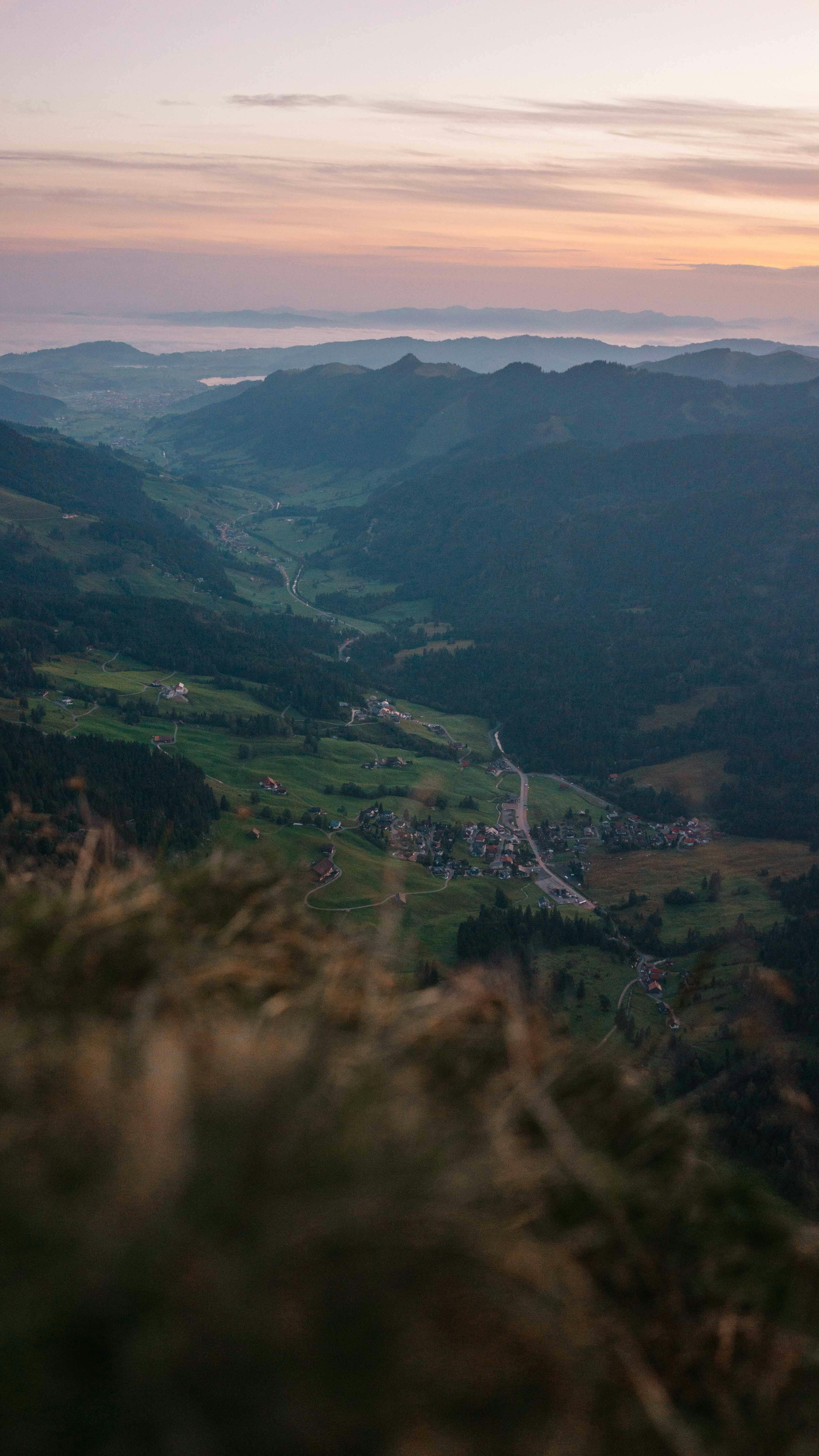 Breathtaking aerial view of a mountain village in Schwyz, Switzerland at sunrise.