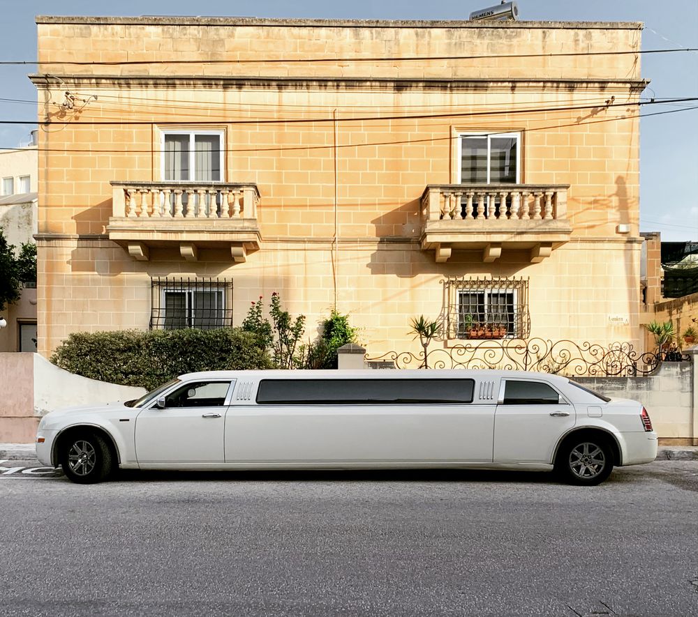 White limousine before a classic villa