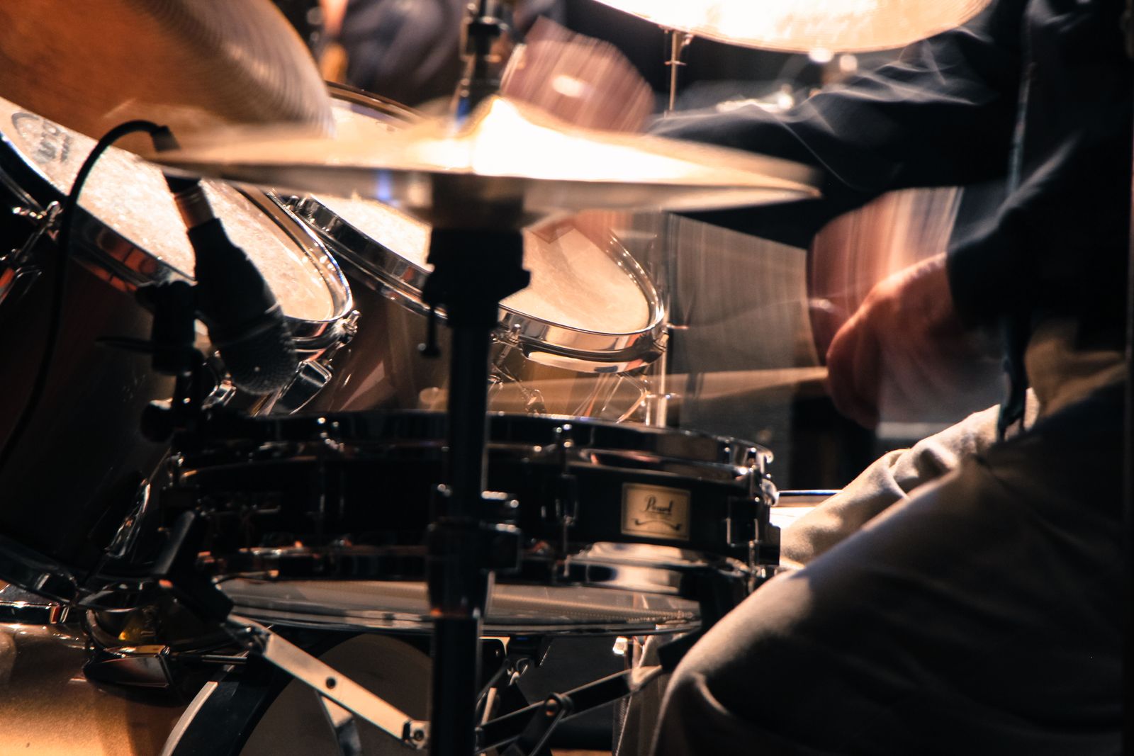 Close-up of a drummer playing passionately, sticks in motion