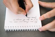 Person Writing on White Paper