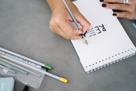 Person Writing on White Paper