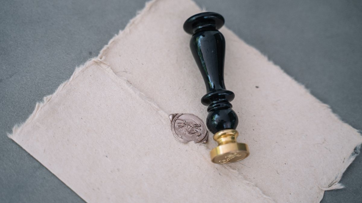 Photo: Anna Tarazevich / Pexels A vintage wax seal and stamp resting on a rumpled linen cloth