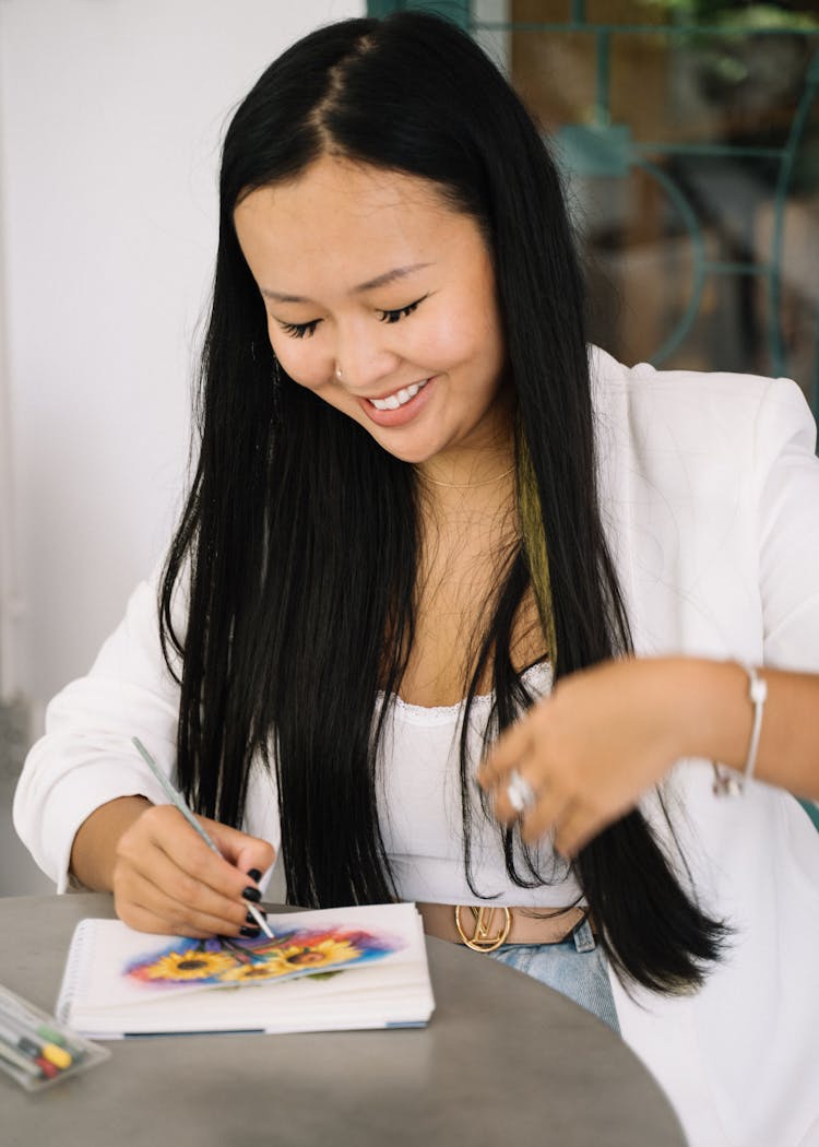 Happy Woman In White Blazer Drawing On A Drawing Pa