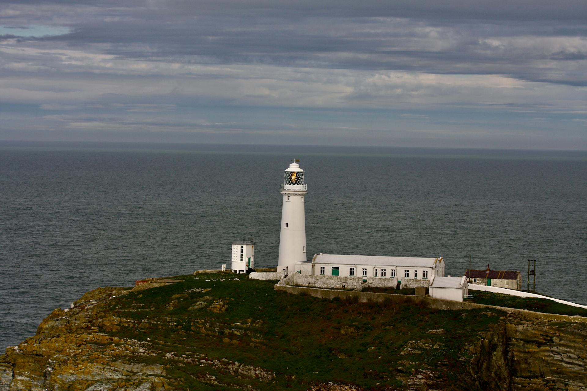 Dramatic view of a coastal lighthouse standing strong against the horizon.