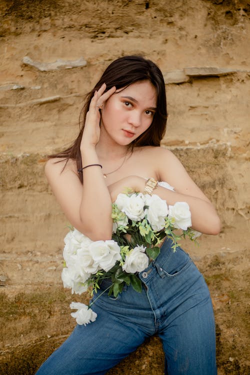 Free Charming young woman covering body with flowers Stock Photo
