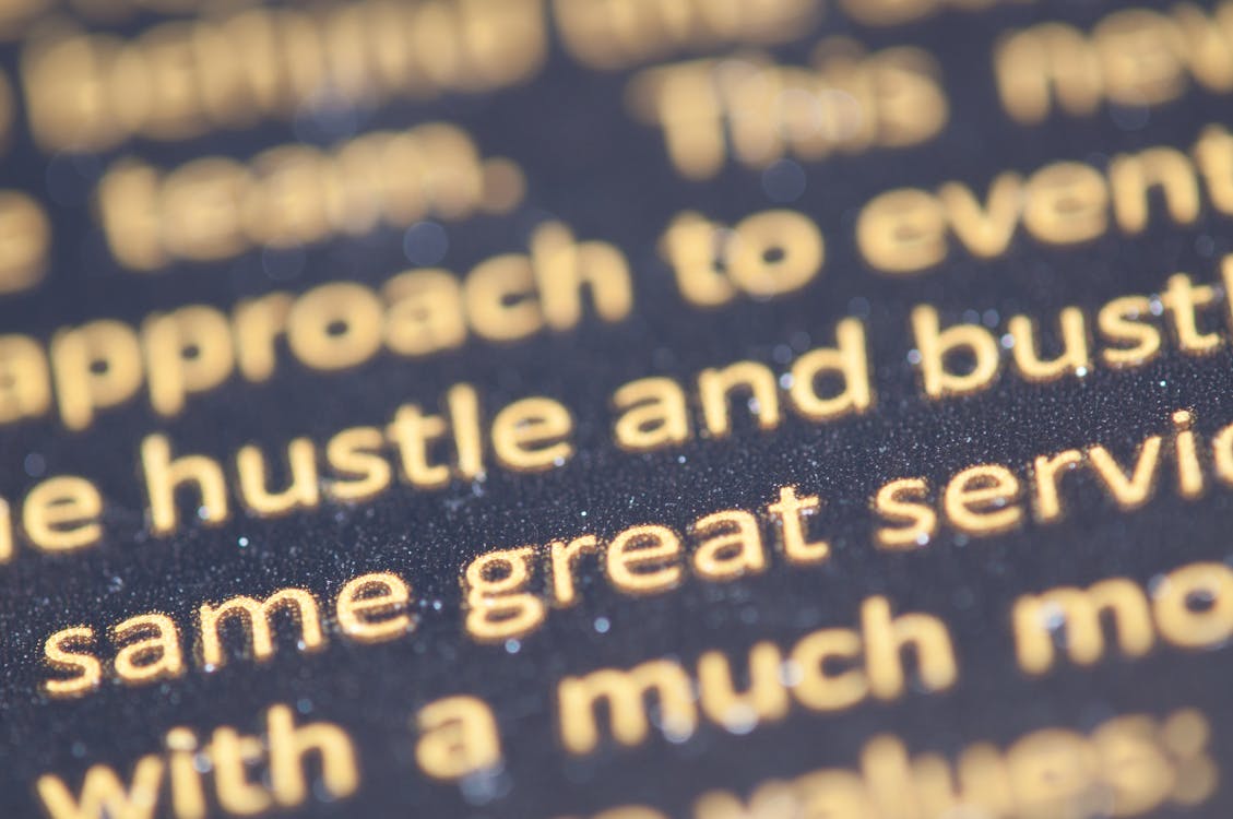 Selective Focus Photography of Hustle and Bust Text