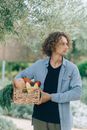 Woman in Blue Cardigan Holding Brown Woven Basket
