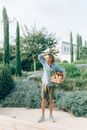 Woman in Gray Hoodie Carrying Brown Basket