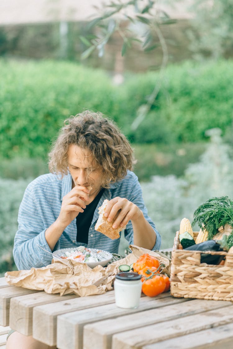 Man Eating A Piece Of Bread