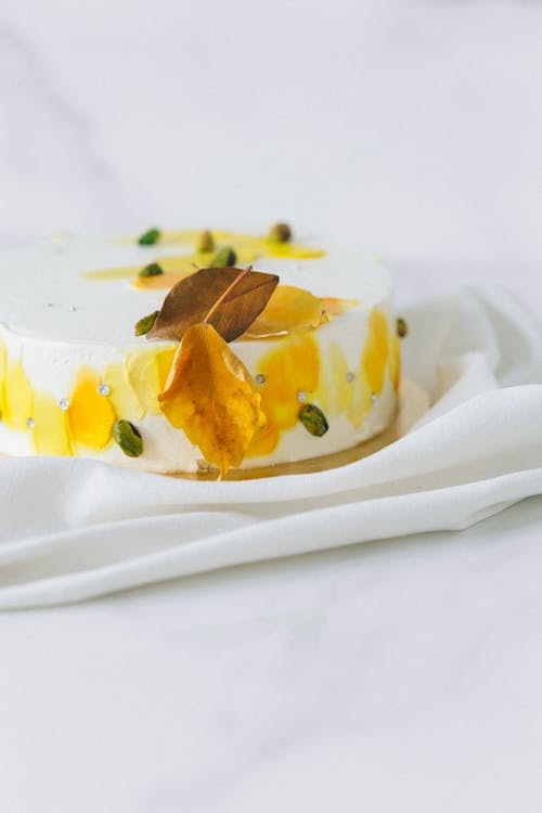 Free Selective Focus Photo of White and Yellow Pistachio Cake Stock Photo