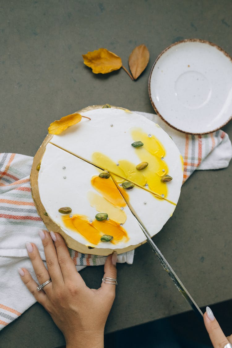 Person Slicing A Cake