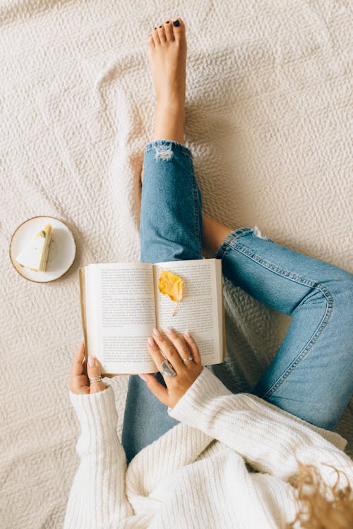 Free Person in Blue Denim Jeans Reading Book Stock Photo