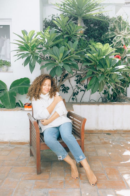 Free Comfy Woman sitting on Wooden Chair  Stock Photo