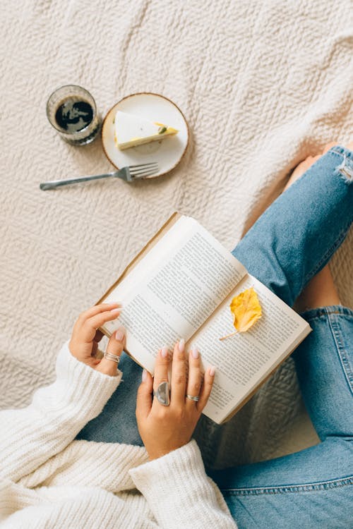 Free Person in Blue Denim Jeans Reading Book Stock Photo